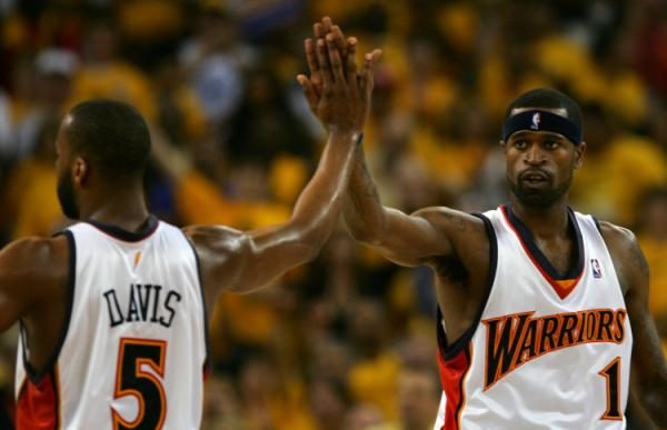 OAKLAND, CA - MAY 13: Stephen Jackson #1 high-fives Baron Davis #5 of the Golden State Warriors in Game 4 of the Western Conference Semifinals against the Utah Jazz during the 2007 NBA Playoffs on May 13, 2007 at Oracle Arena in Oakland, California. NOTE TO USER: User expressly acknowledges and agrees that, by downloading and or using this photograph, User is consenting to the terms and conditions of the Getty Images License Agreement. (Photo by Jed Jacobsohn/Getty Images)